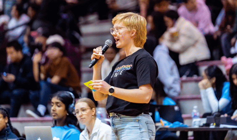 Sarah Cushnie shown speaking at a Pride Game hosted by LAAG